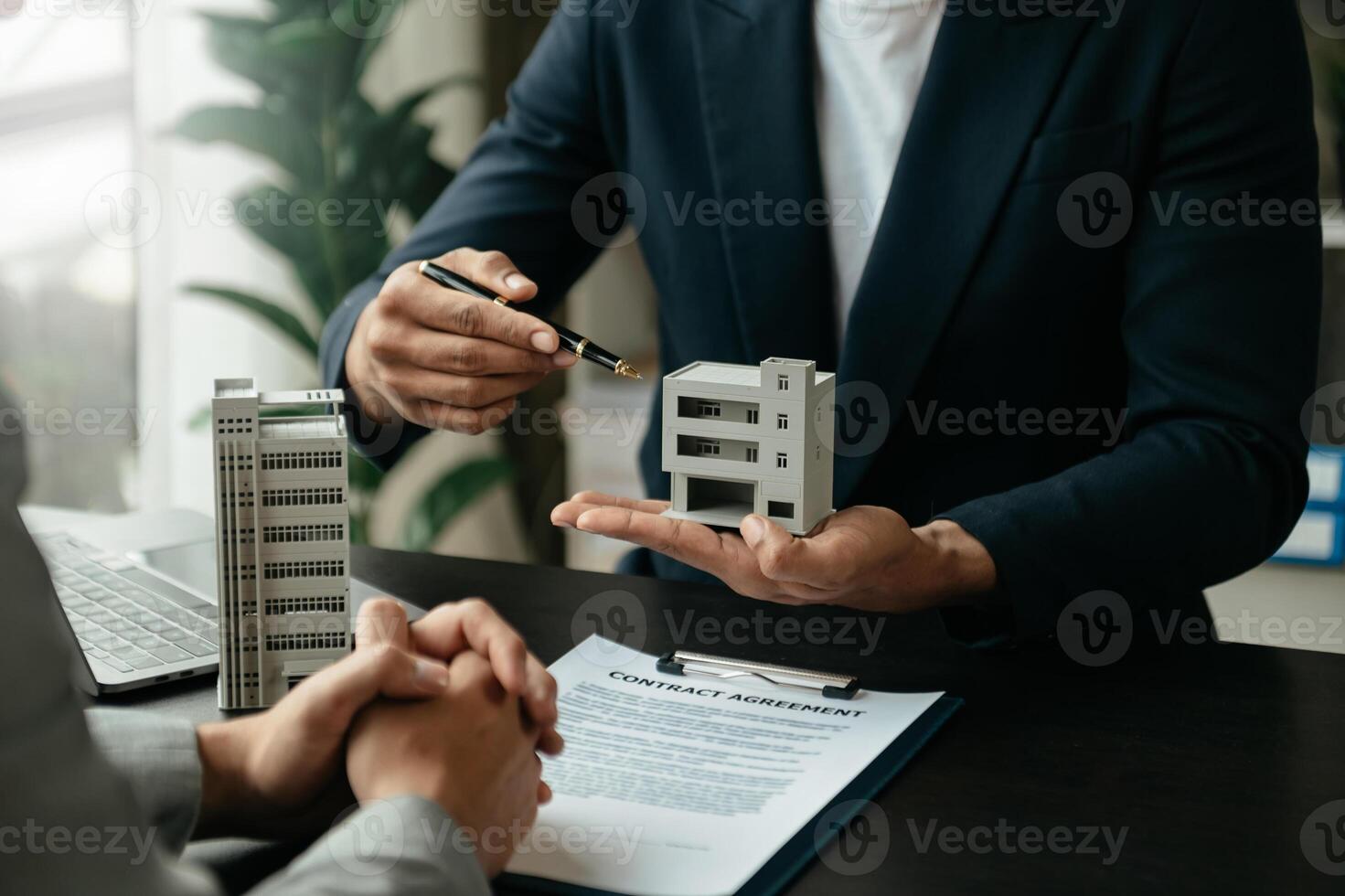 Signing a contract. Client and broker agent, lease agreement, successful deal and  Young business sitting at the desk photo