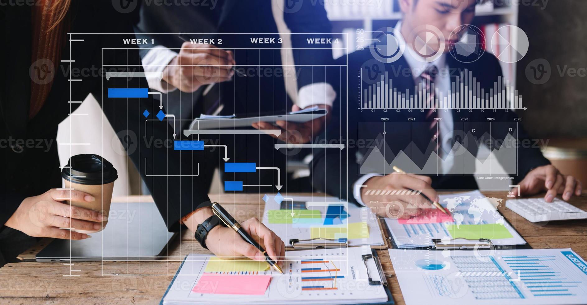 Businessman hand Project manager working and update tasks and Gantt chart scheduling virtual diagram.with smart phone, tablet and laptop in office. photo