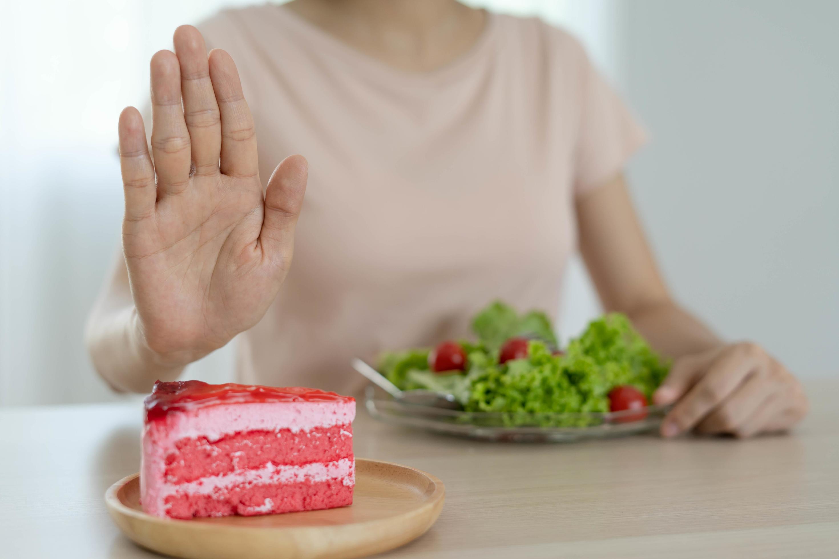 Diet Concept Women Refuse Cake And Eat Salad For Good Health 17155312 diet-concept-women-refuse-cake-and-eat-salad-for-good-health-17155312