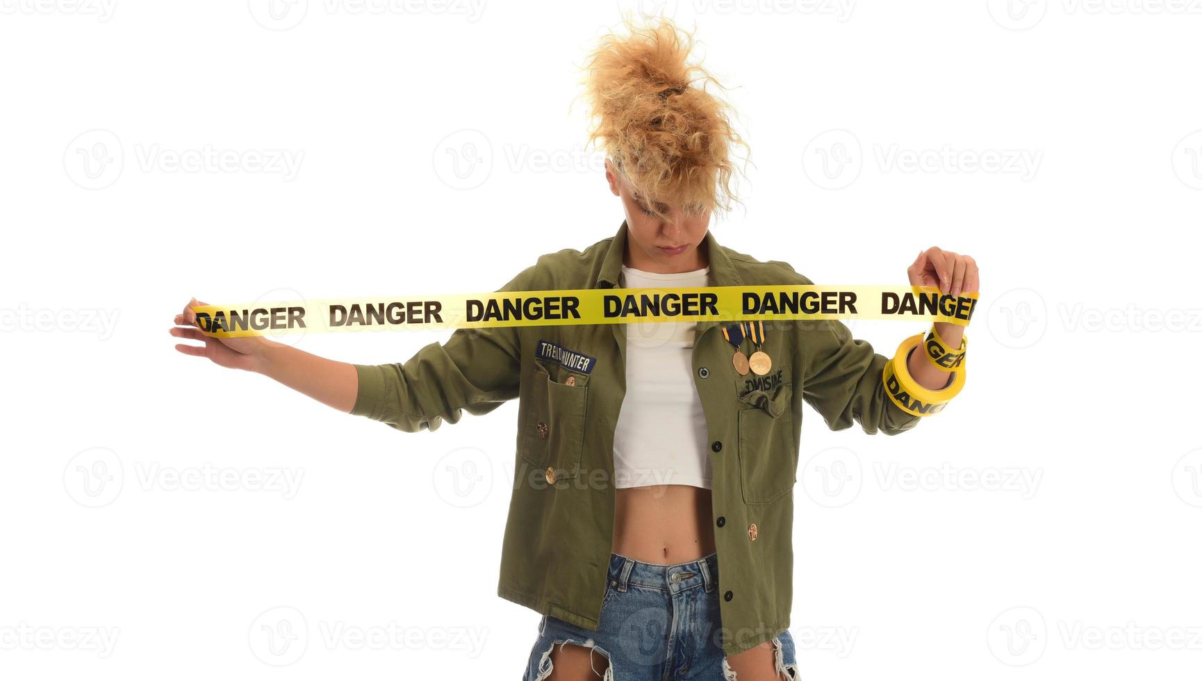 woman smiling with DANGER tape wrapped around her photo