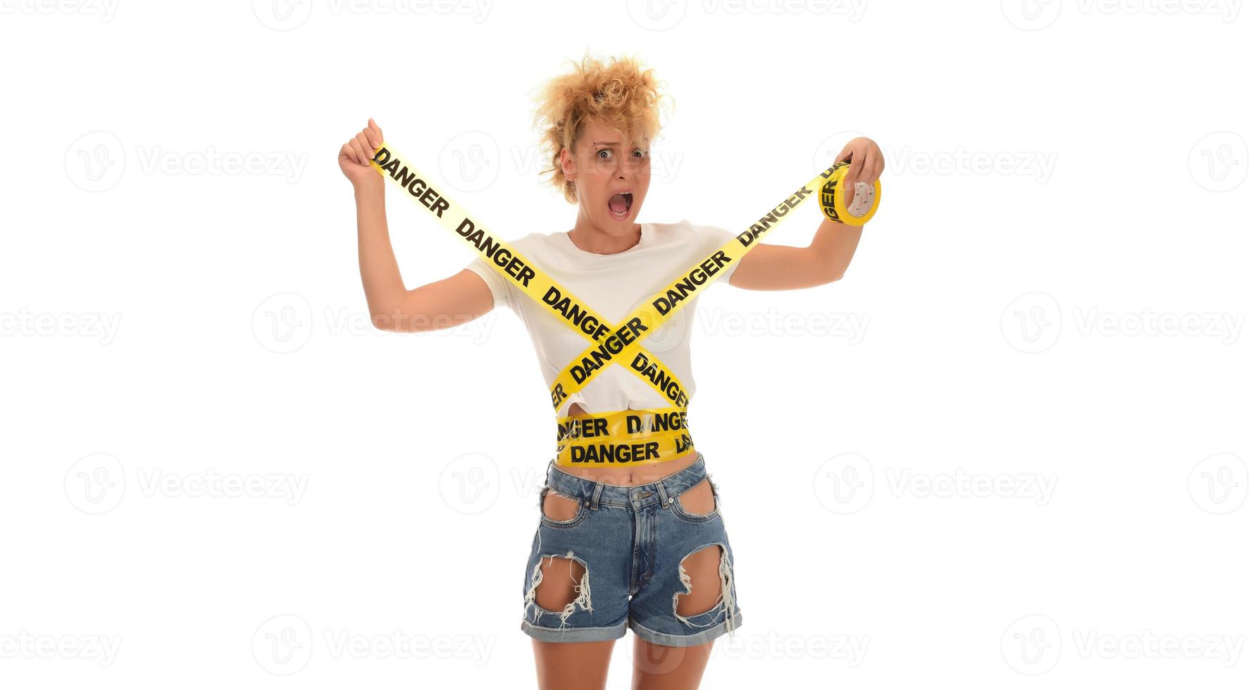 woman smiling with DANGER tape wrapped around her photo