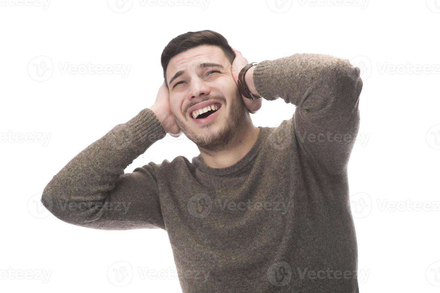 Stop that loud noise. Standing plain young man sad and depressed suffering sorrow and pain screaming desperate with hands on face against  white background. Sadness emotion concept photo