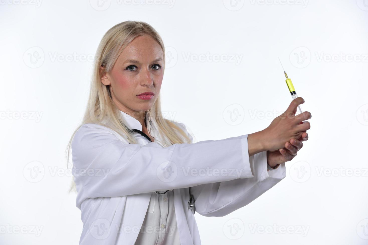 Vaccination and healthcare concept. Female doctor, nurse holding syringe with vaccine, white background photo