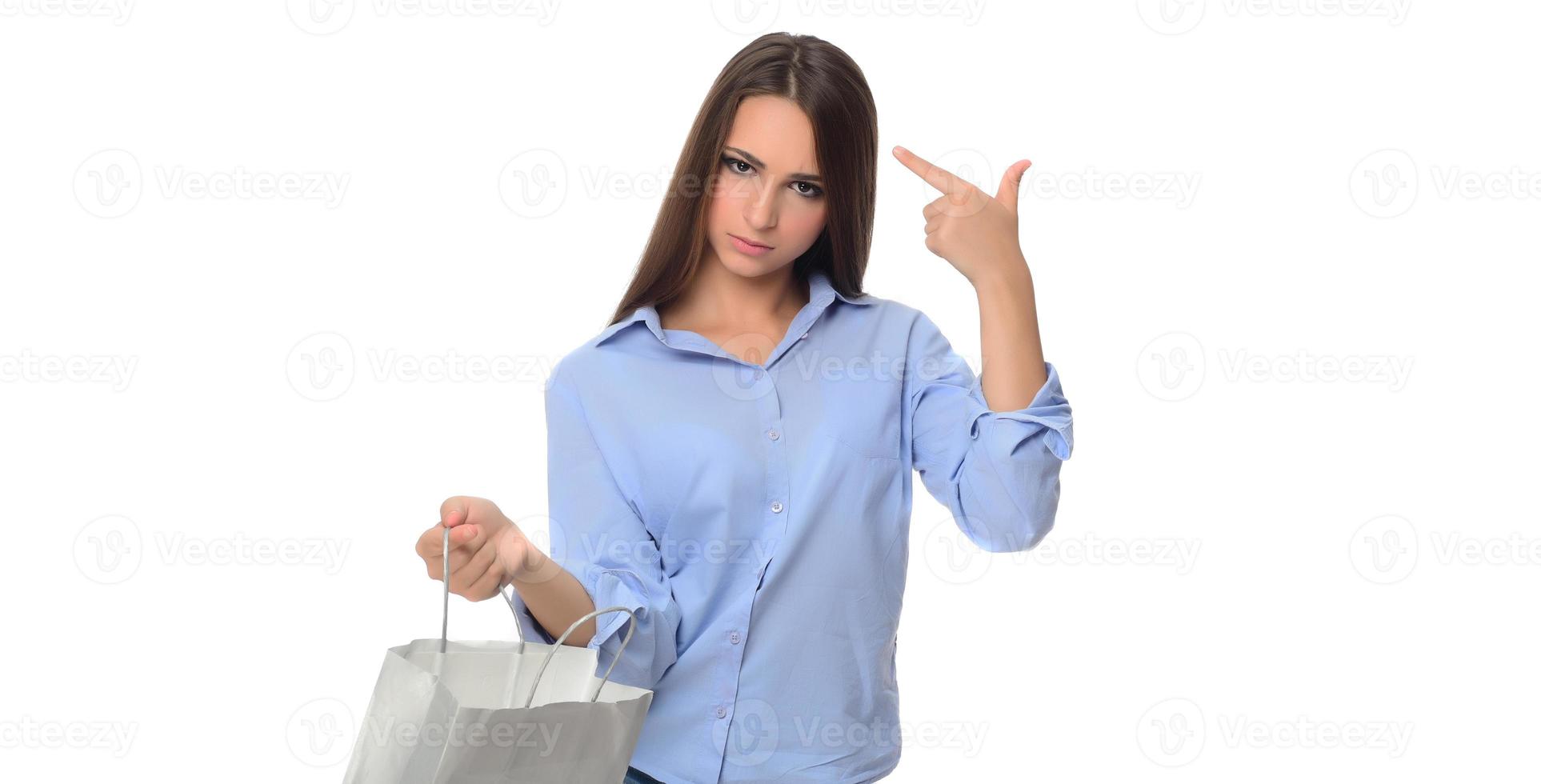 Excited beautiful girl holding shopping bags isolated over gray background photo