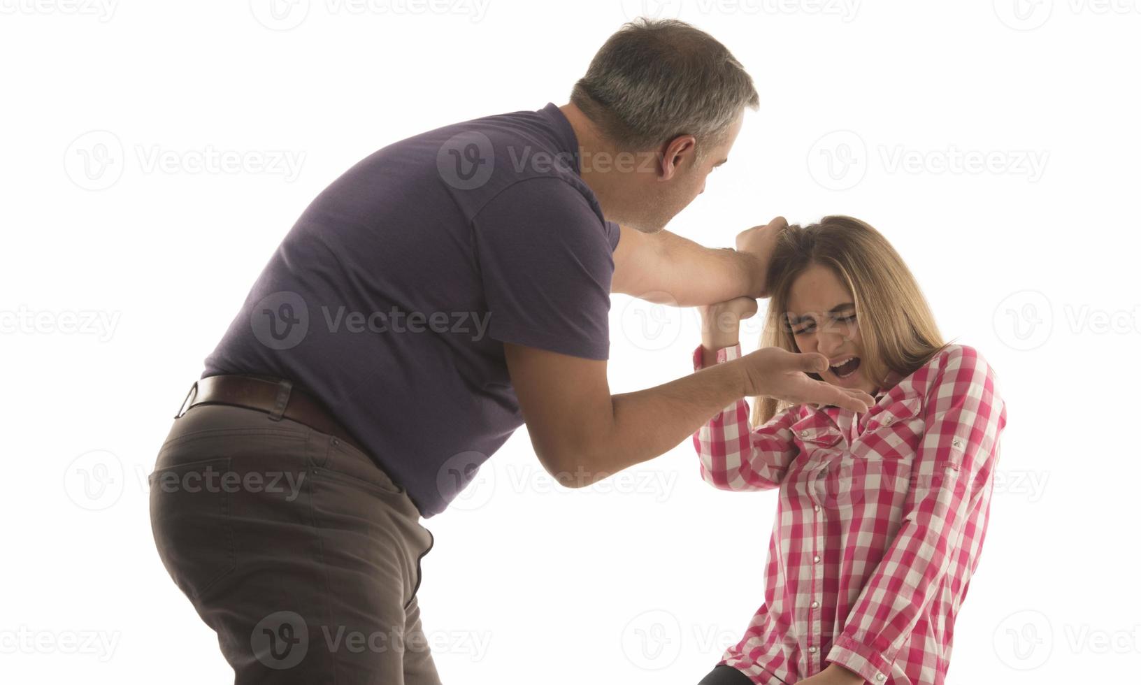 domestic violence, abuse and people concept - man beating helpless woman at home photo