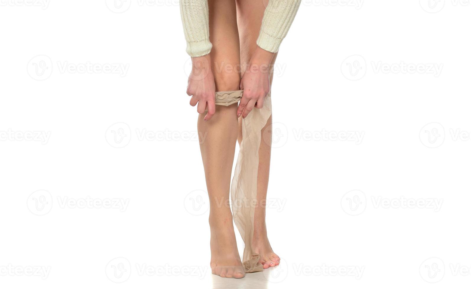 pretty woman puts on her leg nylon stockings photo