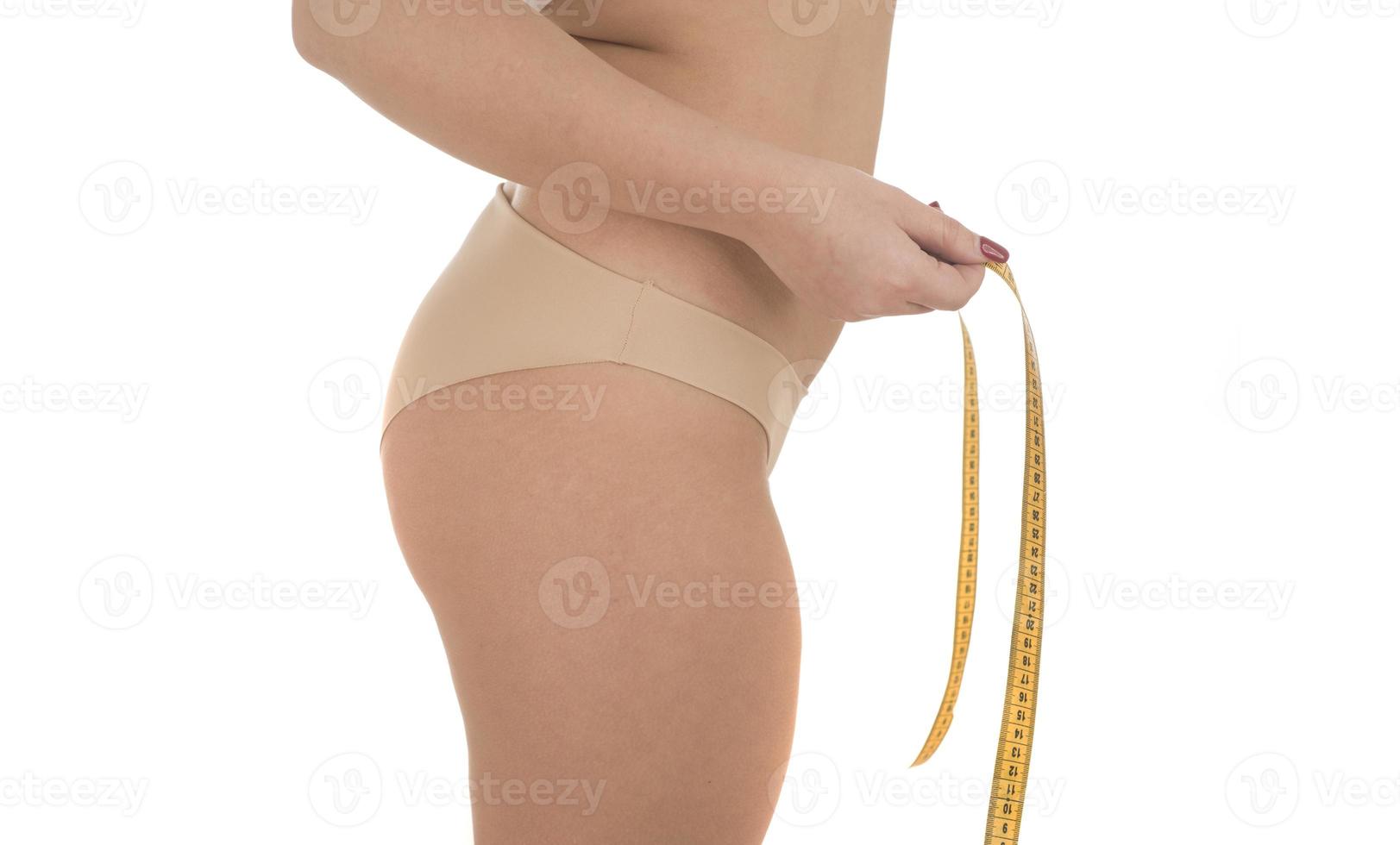 fat woman measuring her stomach overweight, obesity. Isolated on white background. photo