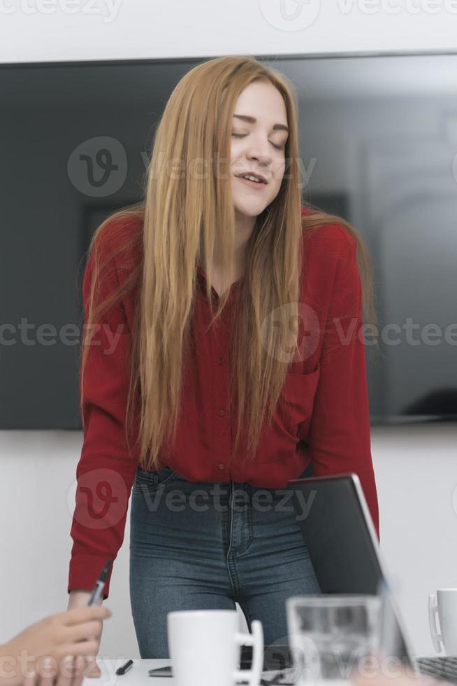 Project Manager Makes a Presentation for a Young Diverse Creative Team in Meeting Room in an Agency. photo