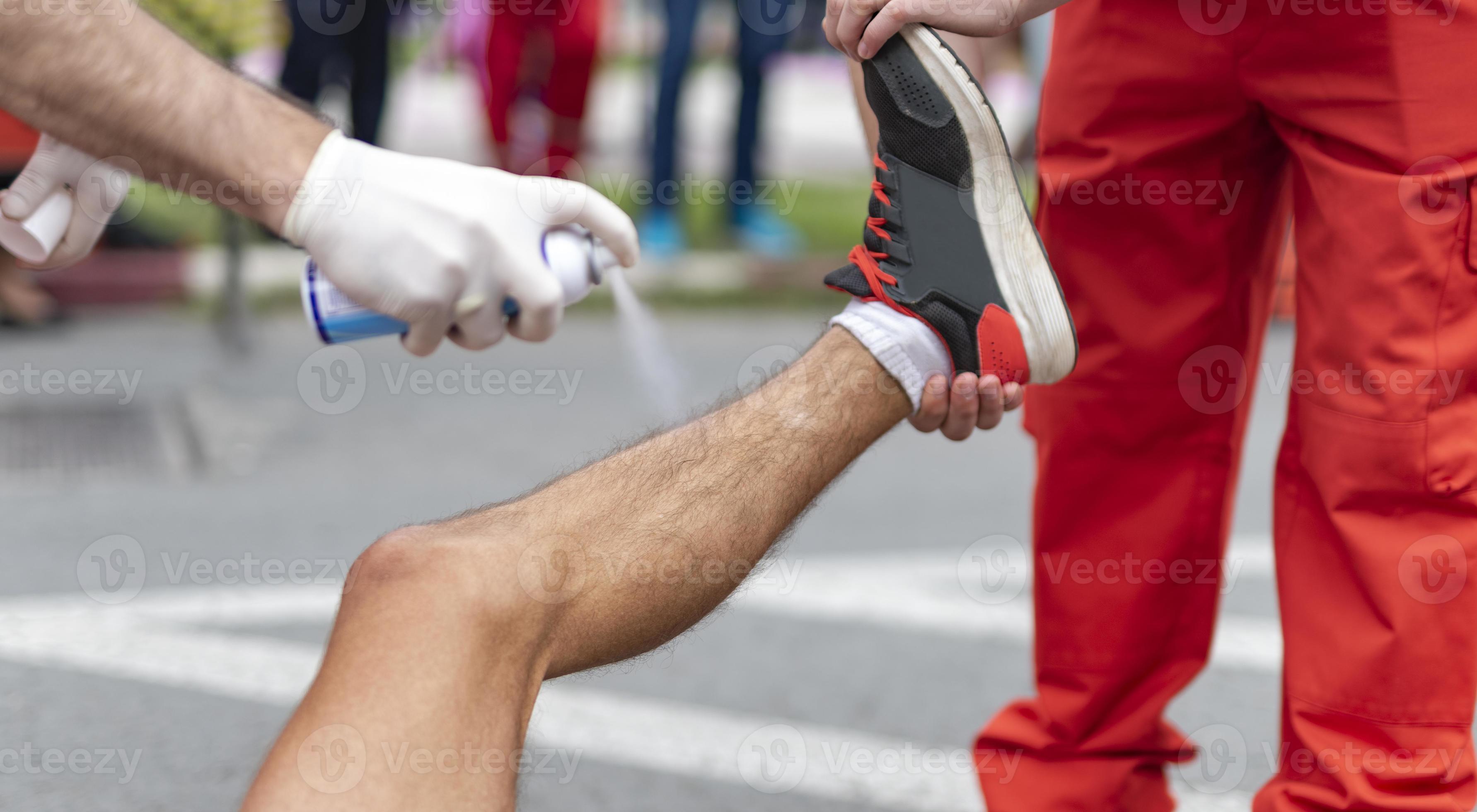 Medical staff using Magic ice spray used to treat a sports injury