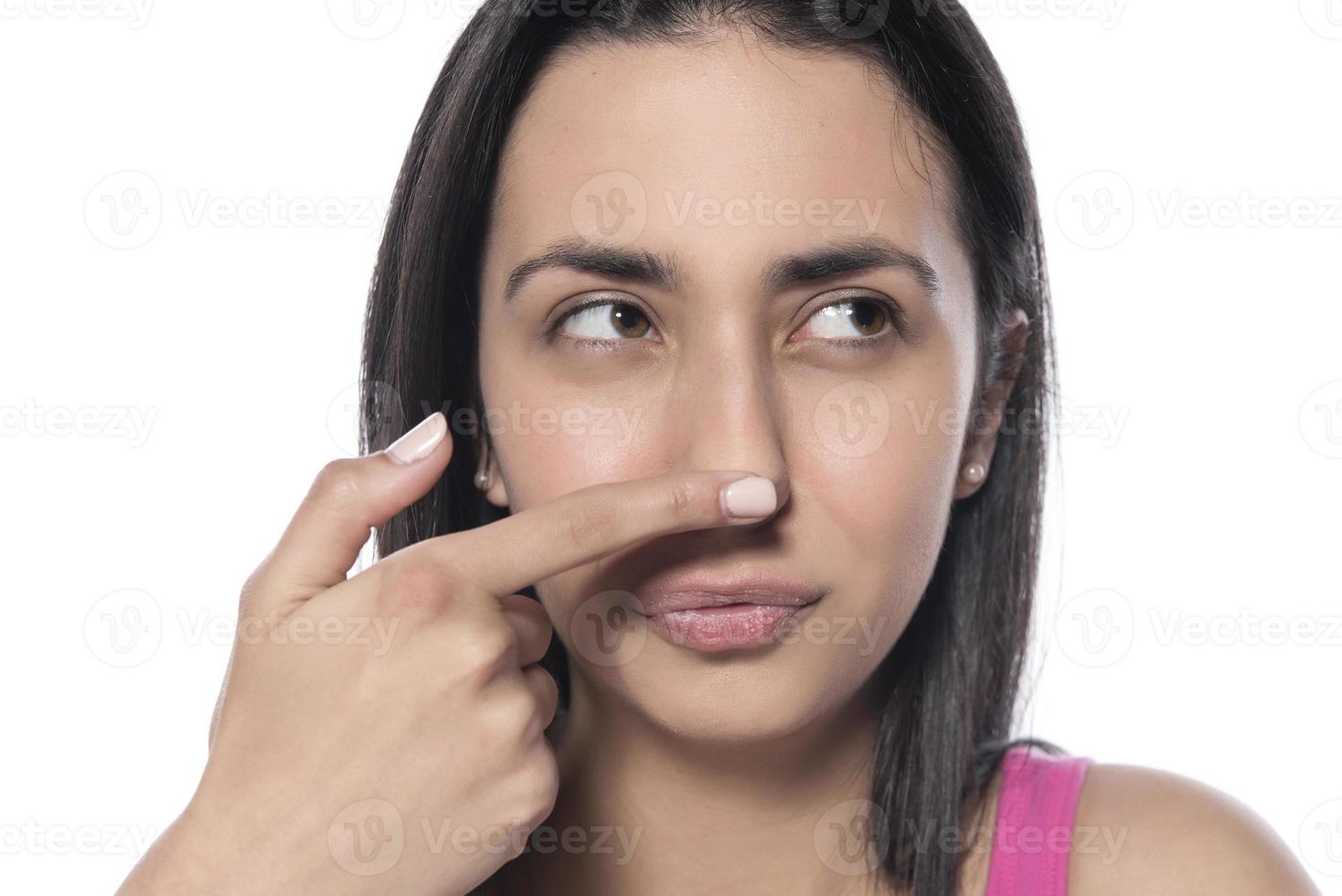 A woman who pinches the fat on her jaw. photo