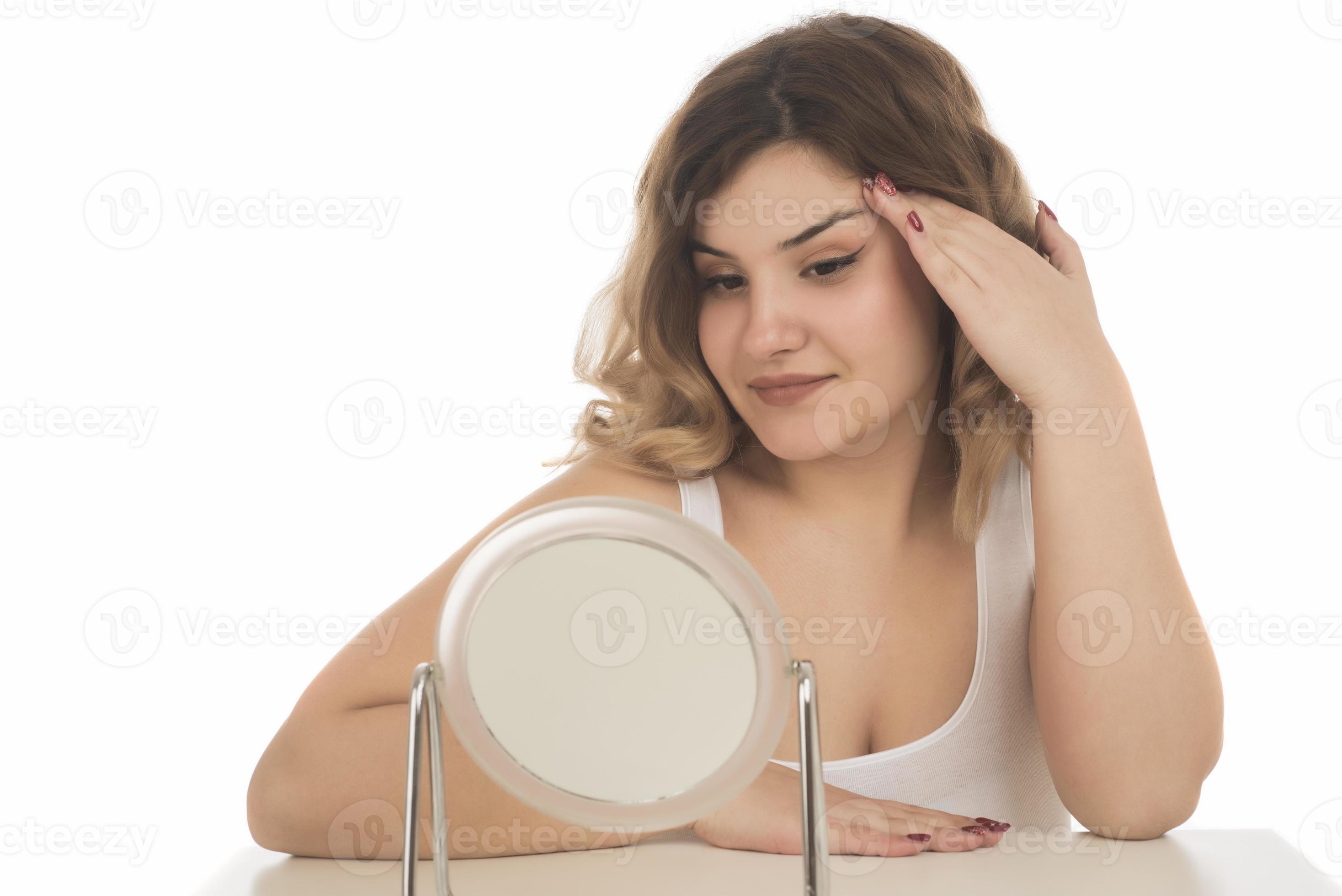 Portrait of pretty charming attractive girl look in mirror touch hands