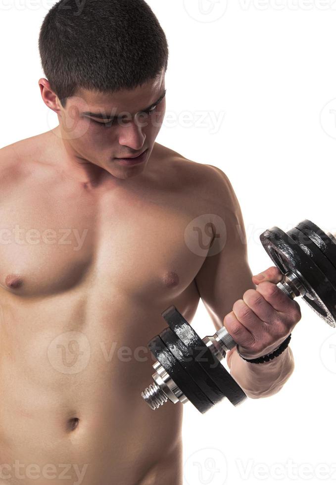 Muscular guy lifting dumbbell photo