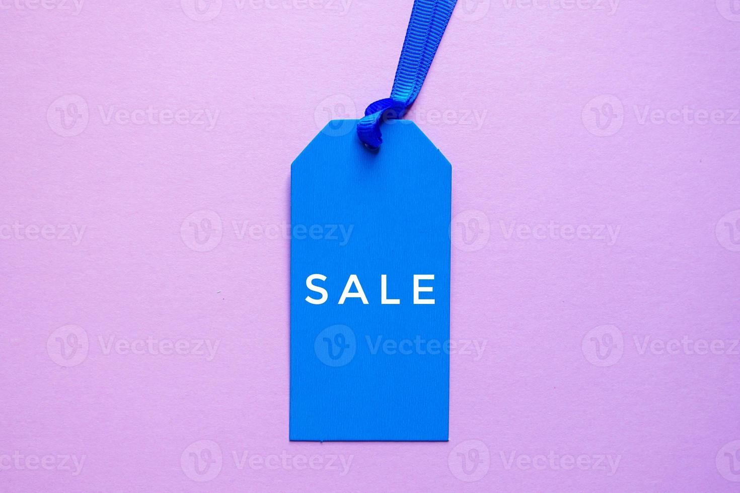 blue price tag with sale word on the pink background, blue mockup photo