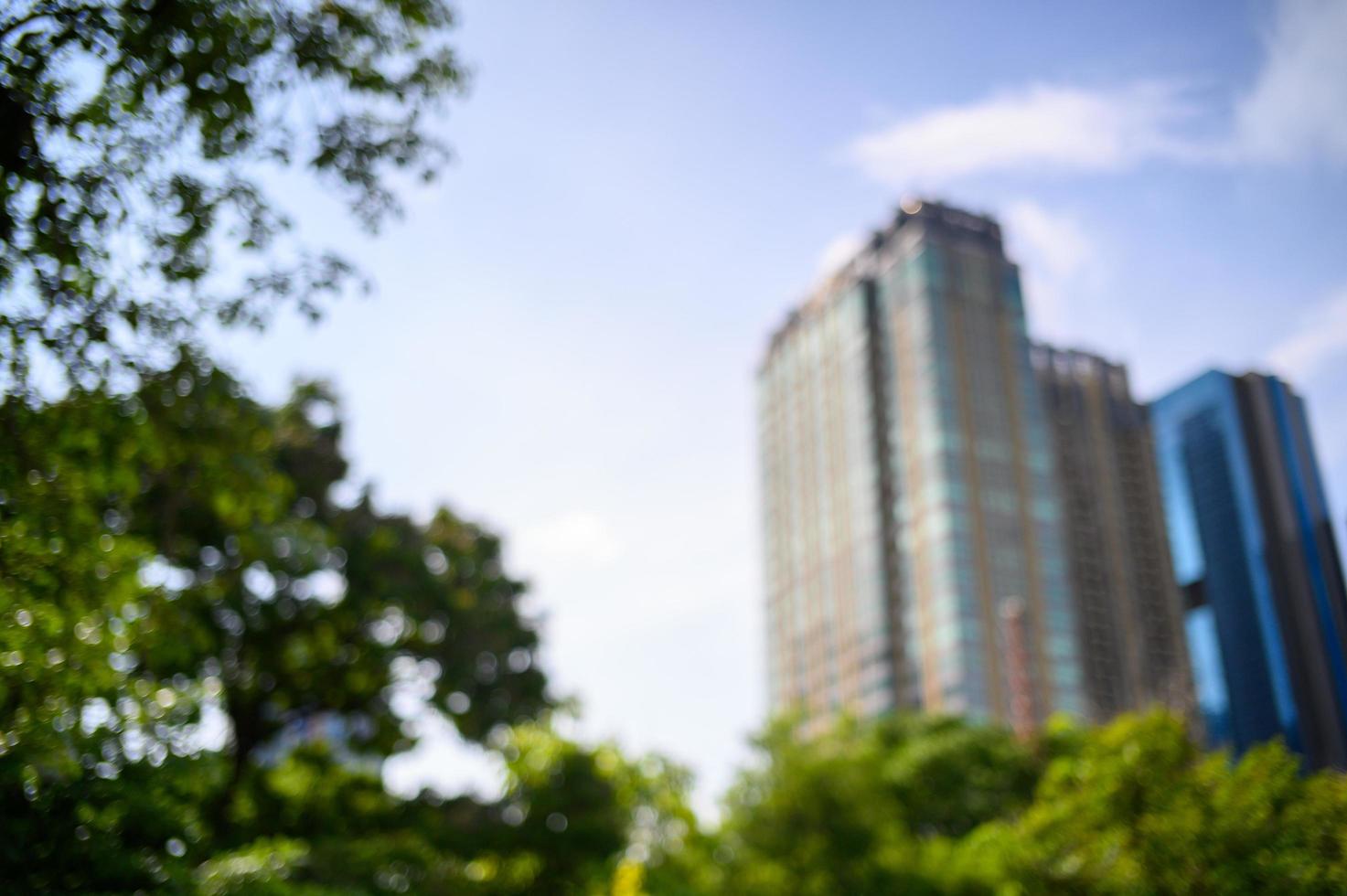 blur background of park with city tower. nature and business concpet photo