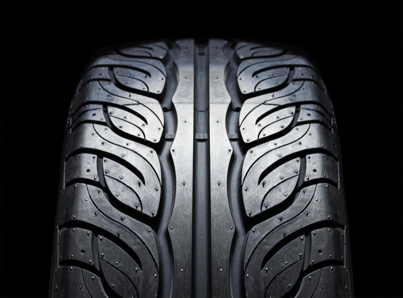 On-road tire tread isolated on black background photo