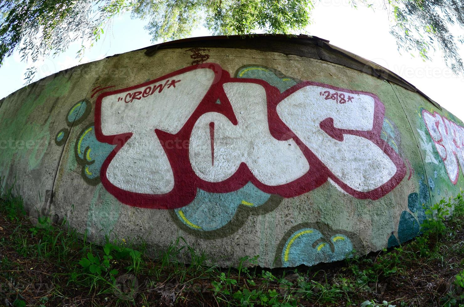 Street art. Abstract background image of a full completed graffiti painting in chrome fill, green background and red outlines. Fisheye photo