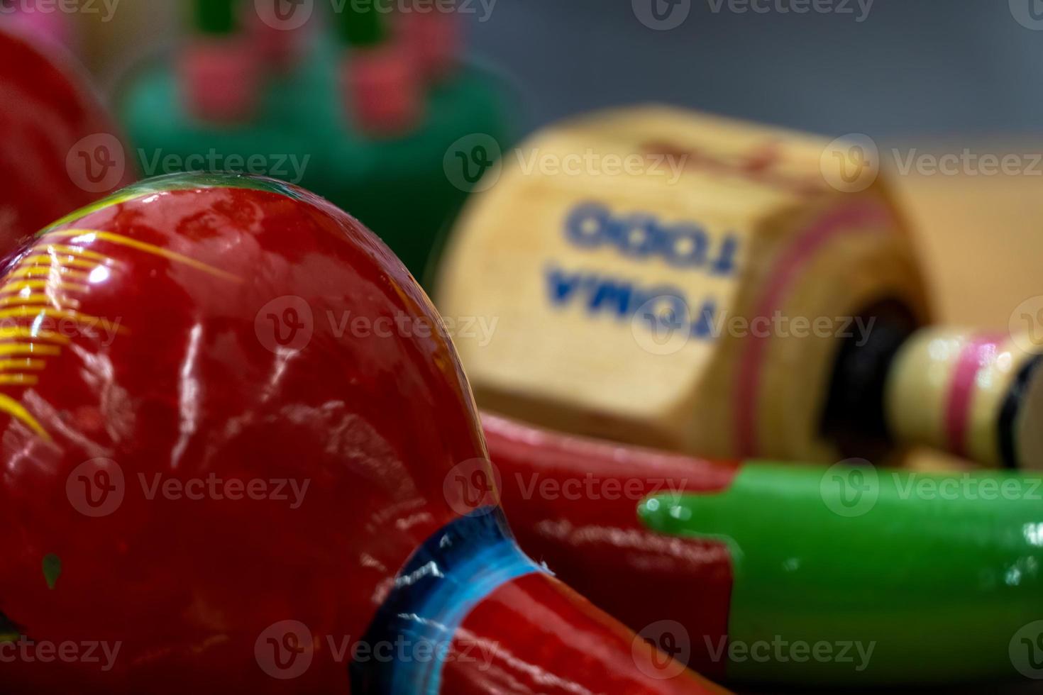 traditional mexican pirinola toy in bold and bright colors in red and wood photo