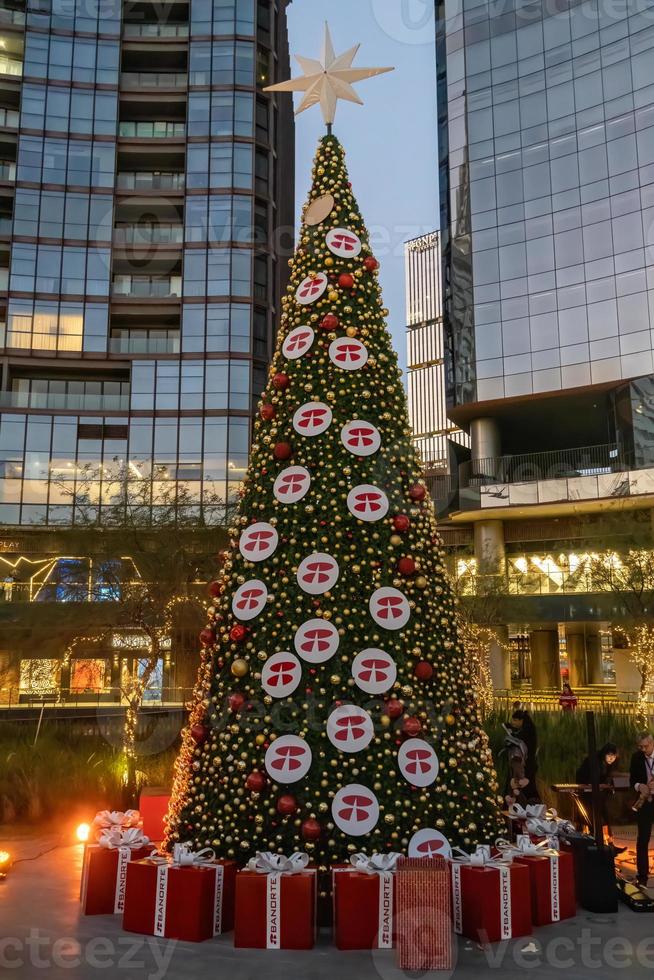 christmas tree tall buildings in the background, christmas and business concept, mexico photo