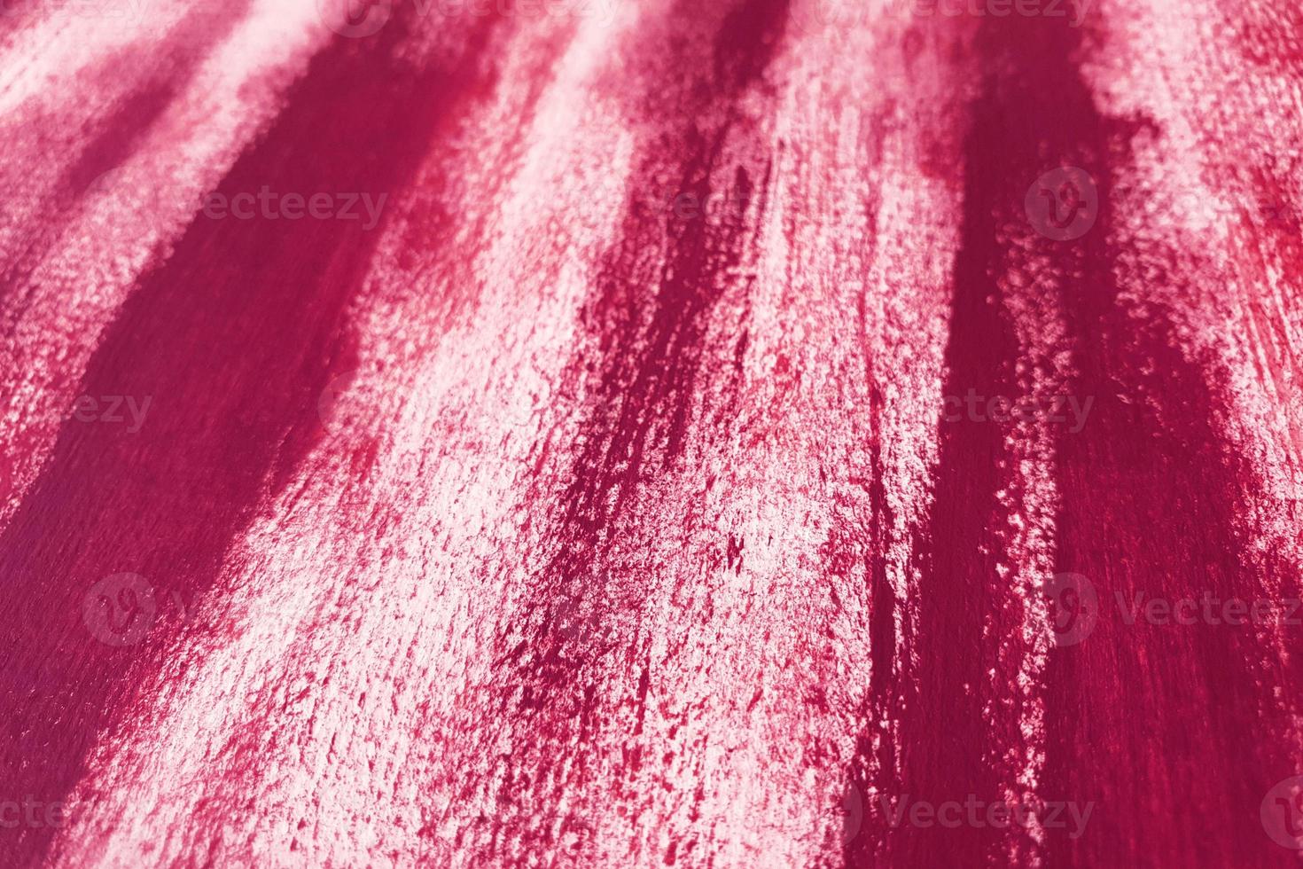 Artistic abstract background with acrylic or gouache violet paint on textured canvas paper. Brushstrokes of dark violet paint. Perspective backdrop with place for text. Selective focus, close up. photo