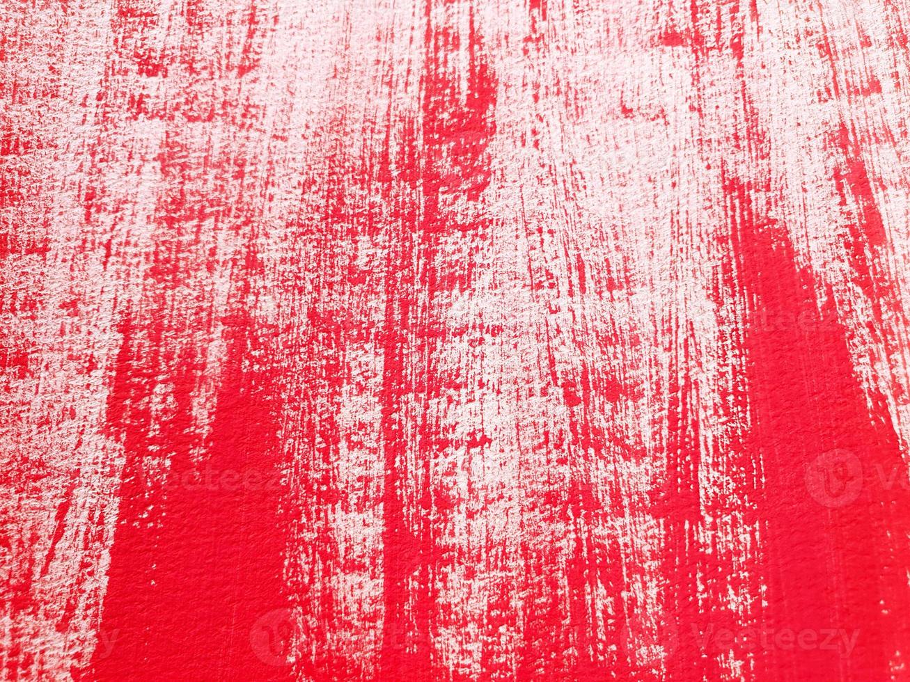 Artistic abstract background with acrylic or gouache red paint on textured canvas paper. Brushstrokes of red paint. Horizontal perspective backdrop with copy space. Selective focus, close up. photo
