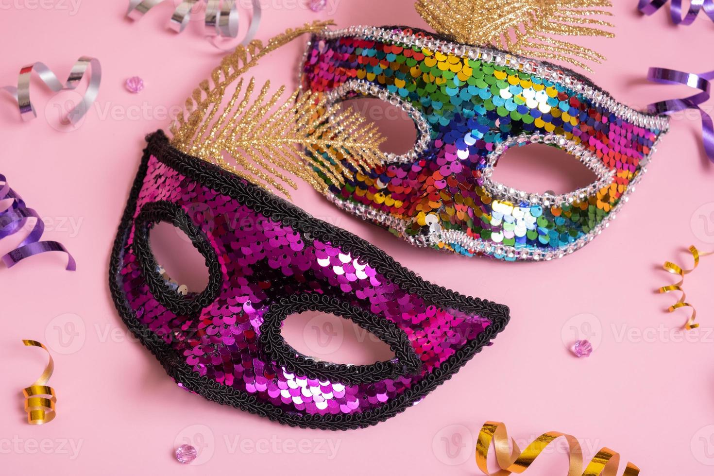Festive face masks for carnival celebration on colored background. Carnival concept photo
