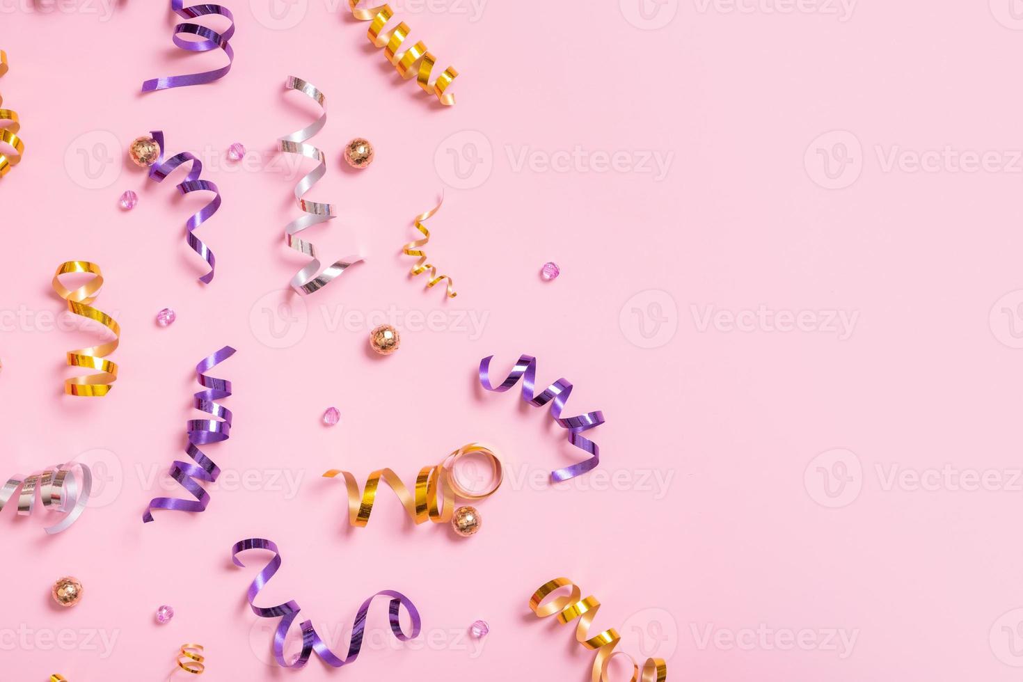 Colorful spiral tinsel and beads on colored background. Copy space photo