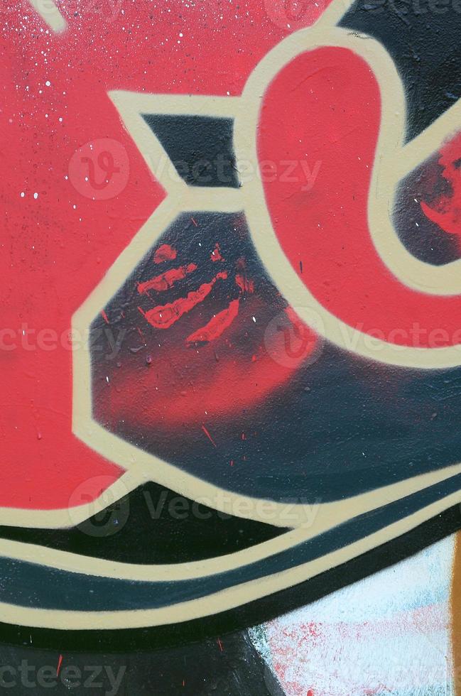 Street art. Abstract background image of a fragment of a colored graffiti painting in red tones photo