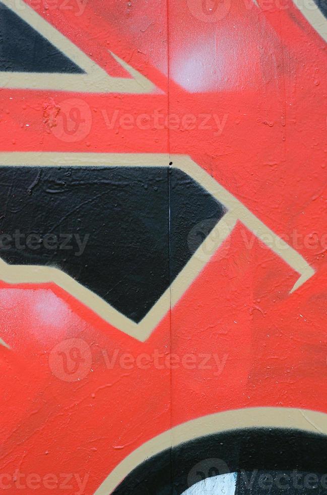 Street art. Abstract background image of a fragment of a colored graffiti painting in red tones photo