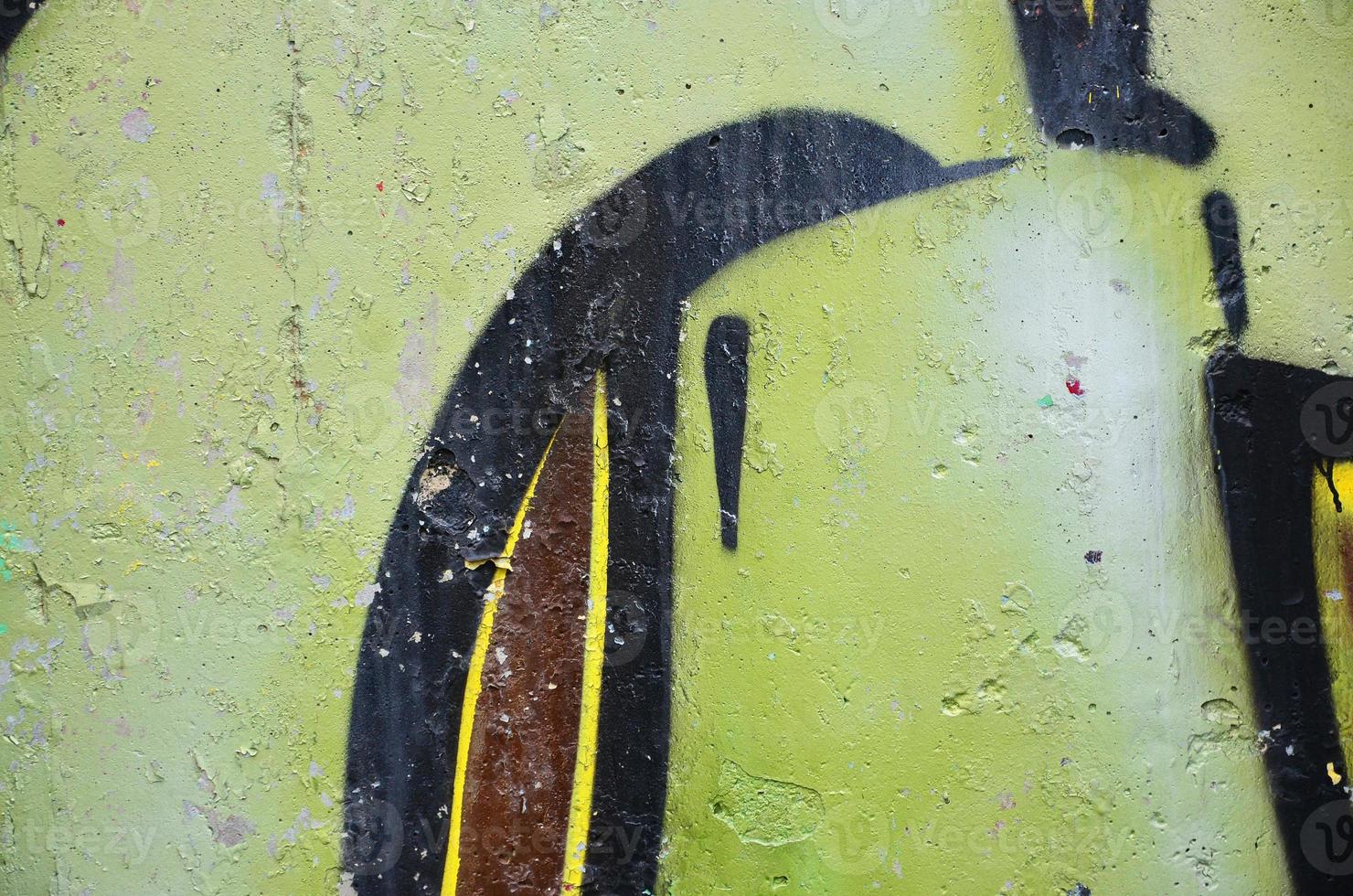 Texture of a fragment of the wall with graffiti painting, which is depicted on it. An image of a piece of graffiti drawing as a photo on street art and graffiti culture topics