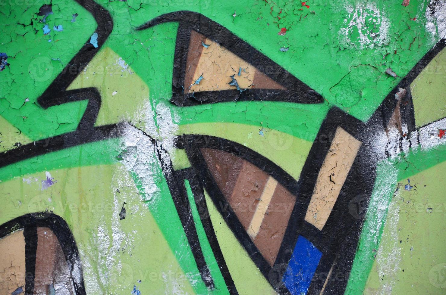 Texture of a fragment of the wall with graffiti painting, which is depicted on it. An image of a piece of graffiti drawing as a photo on street art and graffiti culture topics
