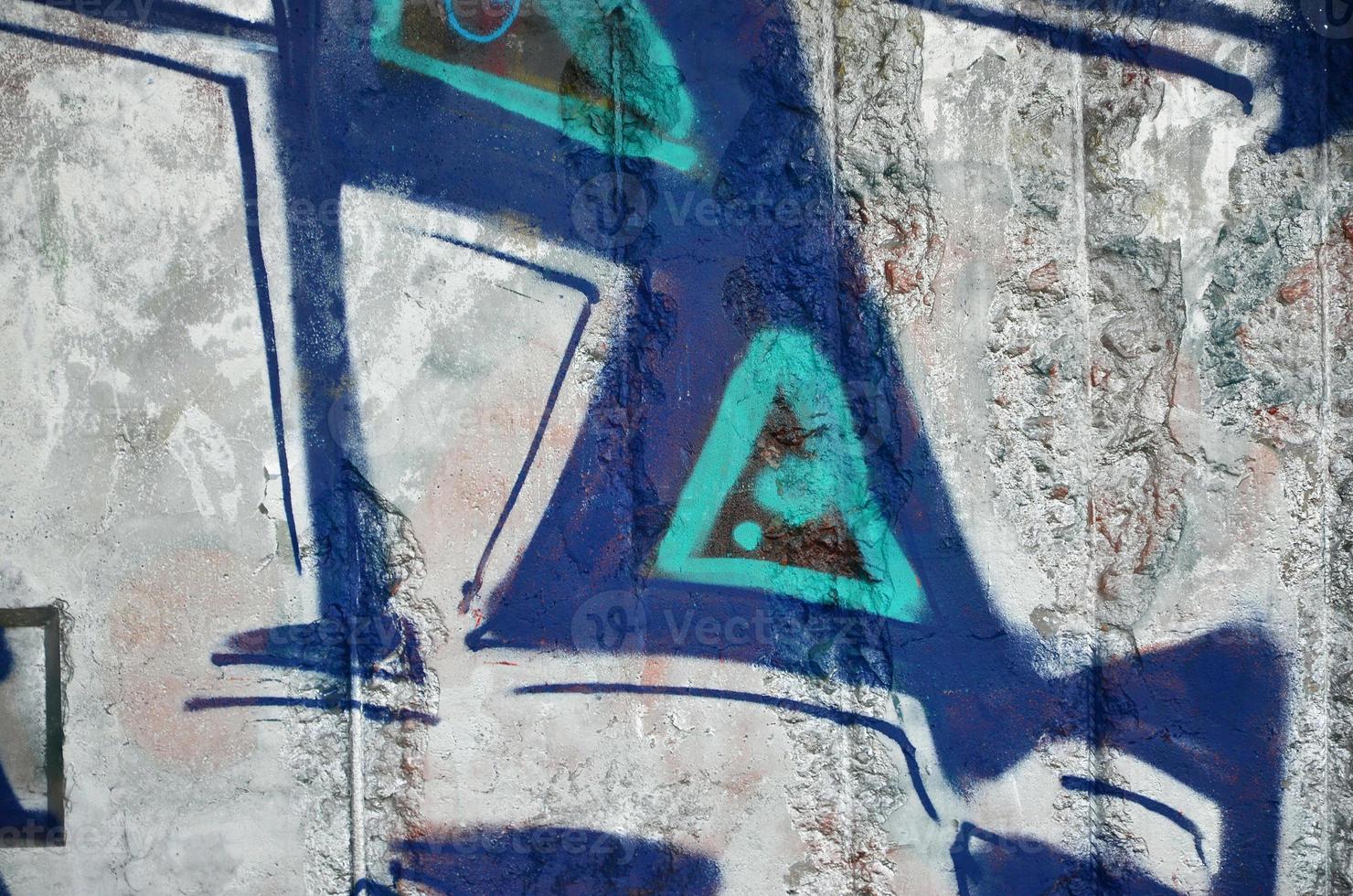 Texture of a fragment of the wall with graffiti painting, which is depicted on it. An image of a piece of graffiti drawing as a photo on street art and graffiti culture topics