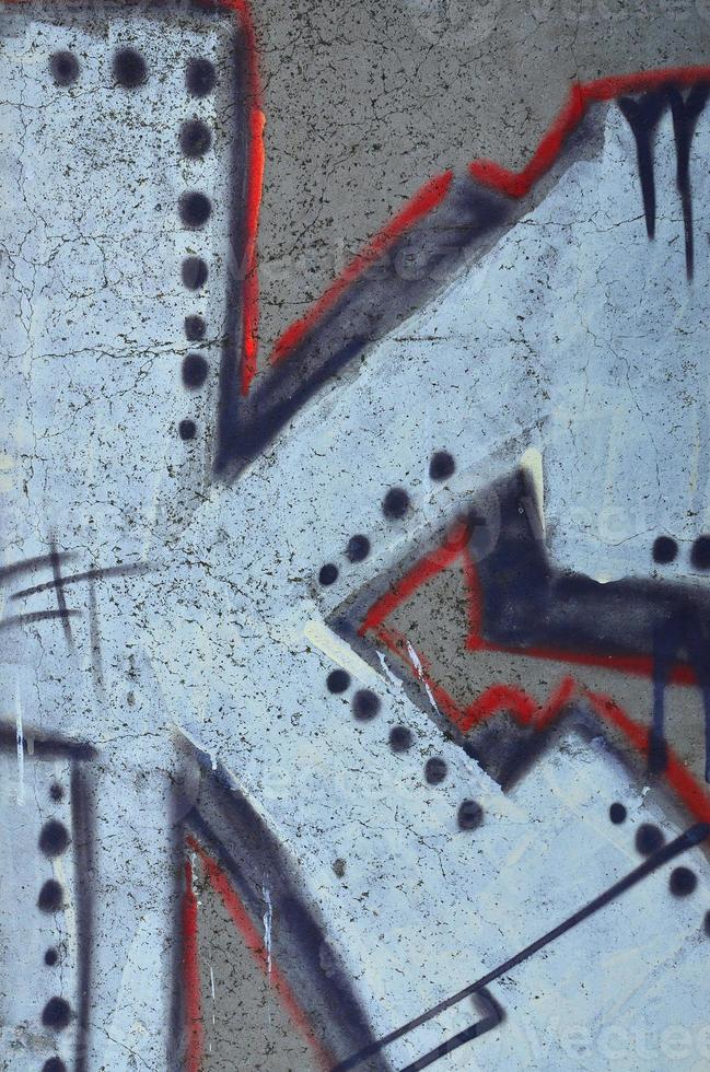 Texture of a fragment of the wall with graffiti painting, which is depicted on it. An image of a piece of graffiti drawing as a photo on street art and graffiti culture topics