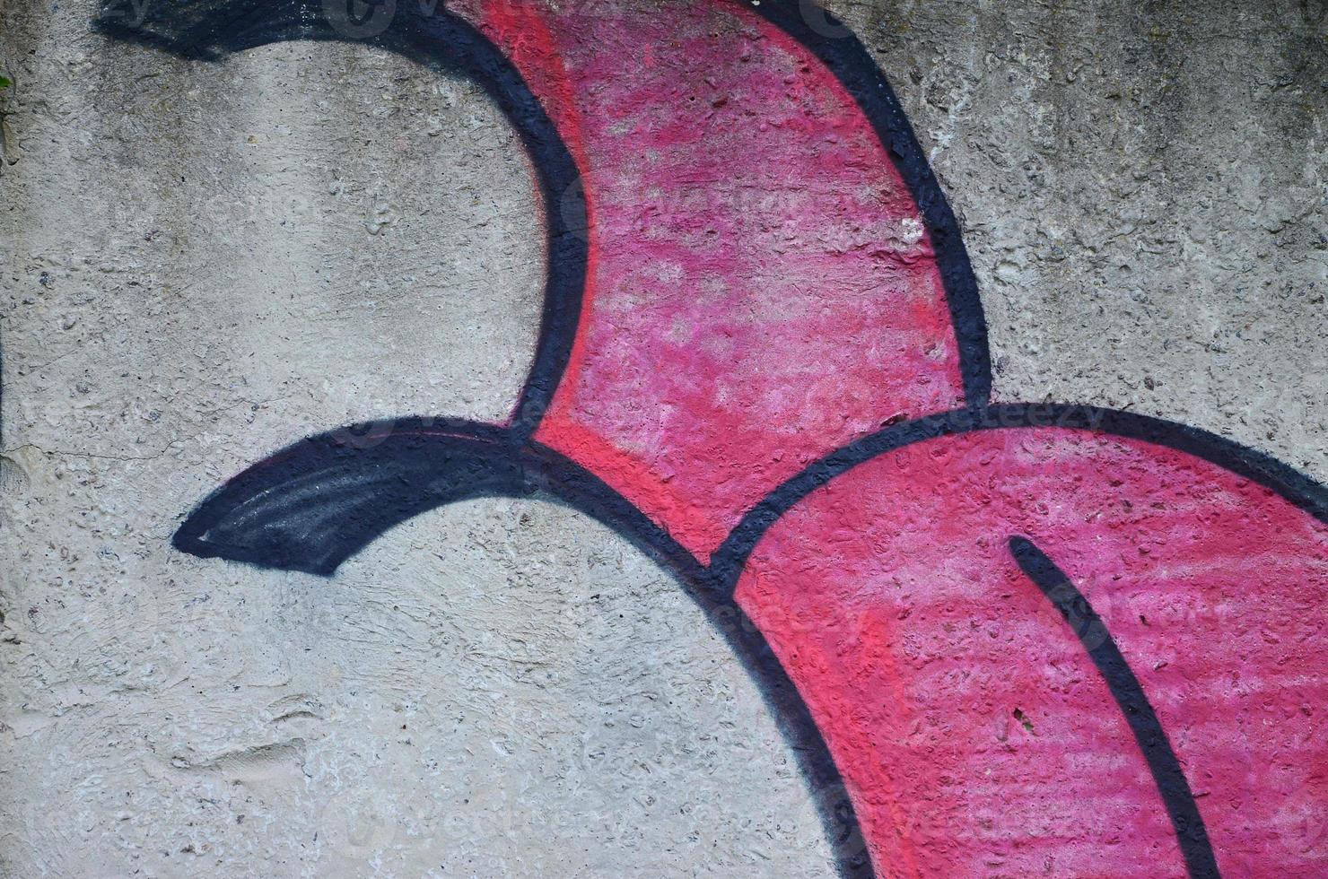 Texture of a fragment of the wall with graffiti painting, which is depicted on it. An image of a piece of graffiti drawing as a photo on street art and graffiti culture topics