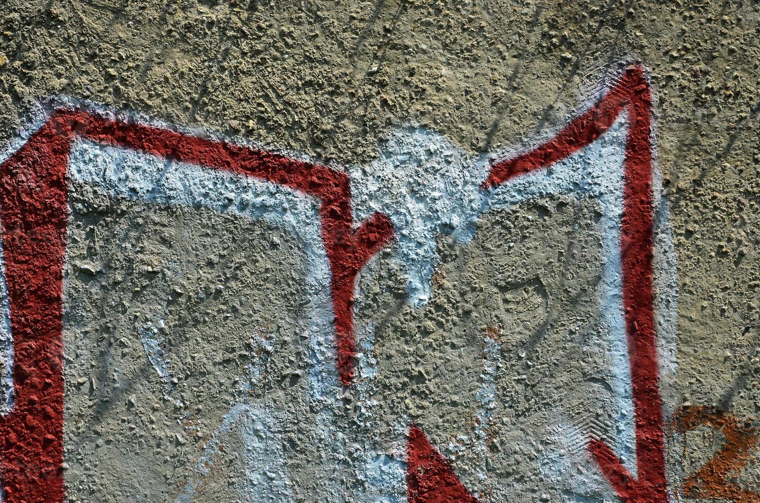 Texture of a fragment of the wall with graffiti painting, which is depicted on it. An image of a piece of graffiti drawing as a photo on street art and graffiti culture topics
