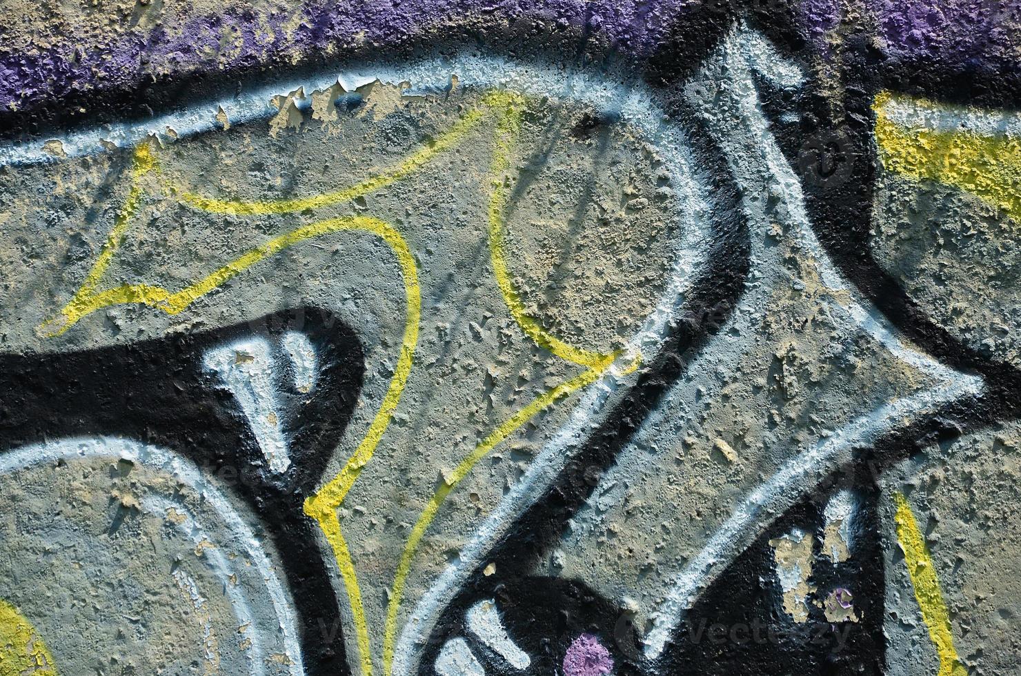 Texture of a fragment of the wall with graffiti painting, which is depicted on it. An image of a piece of graffiti drawing as a photo on street art and graffiti culture topics