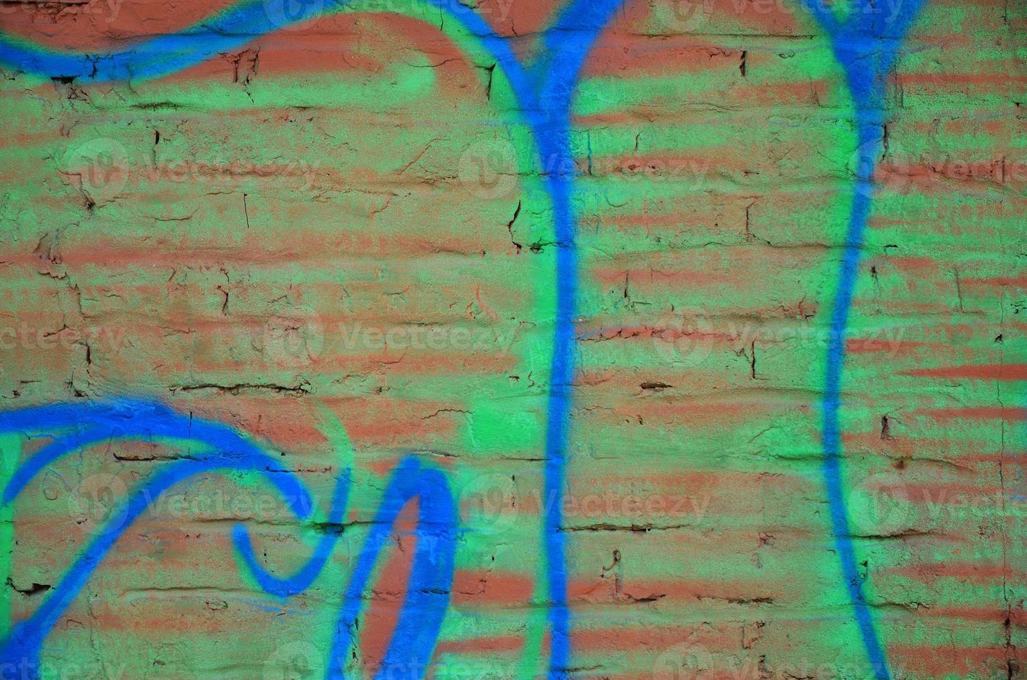 Texture of a fragment of the wall with graffiti painting, which is depicted on it. An image of a piece of graffiti drawing as a photo on street art and graffiti culture topics