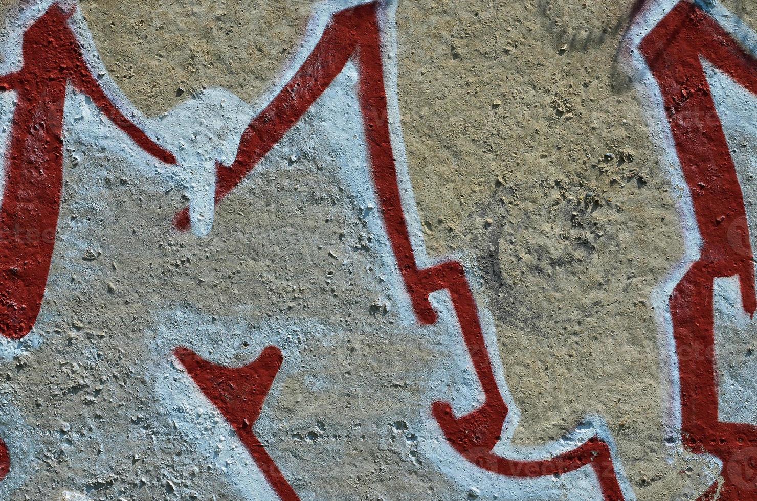 Texture of a fragment of the wall with graffiti painting, which is depicted on it. An image of a piece of graffiti drawing as a photo on street art and graffiti culture topics