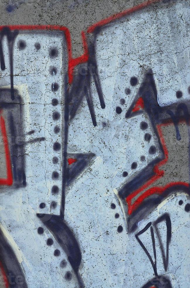 Texture of a fragment of the wall with graffiti painting, which is depicted on it. An image of a piece of graffiti drawing as a photo on street art and graffiti culture topics