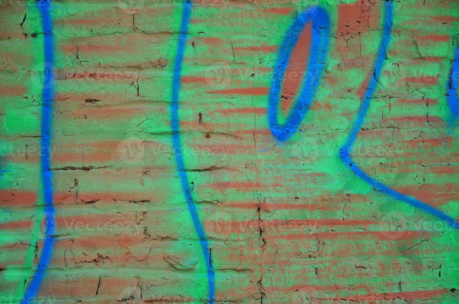 Texture of a fragment of the wall with graffiti painting, which is depicted on it. An image of a piece of graffiti drawing as a photo on street art and graffiti culture topics