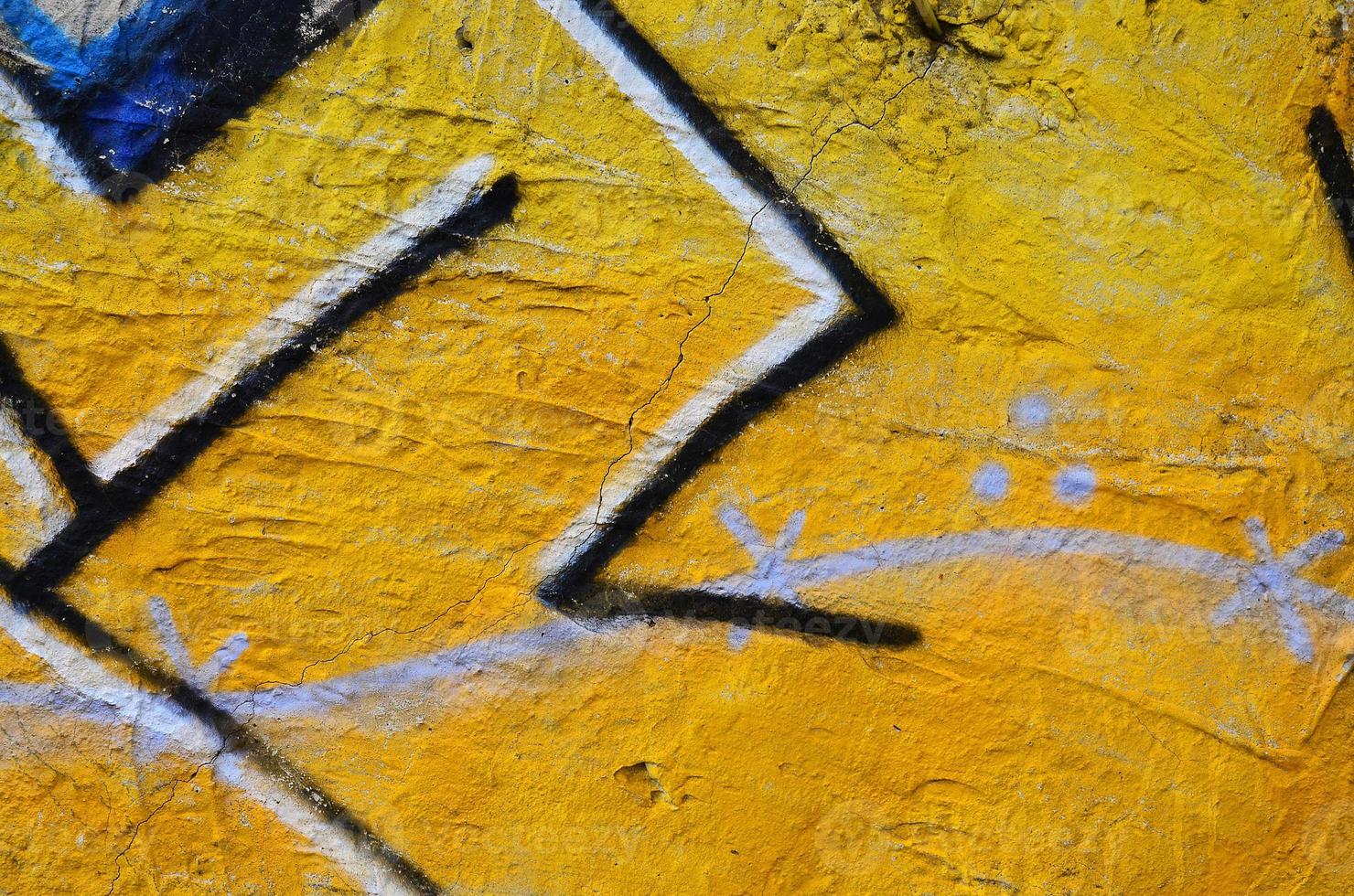 Close up view of graffiti drawing details. Background image on the theme of street art and vandalism. Texture of the wall, painted with aerosol paints photo