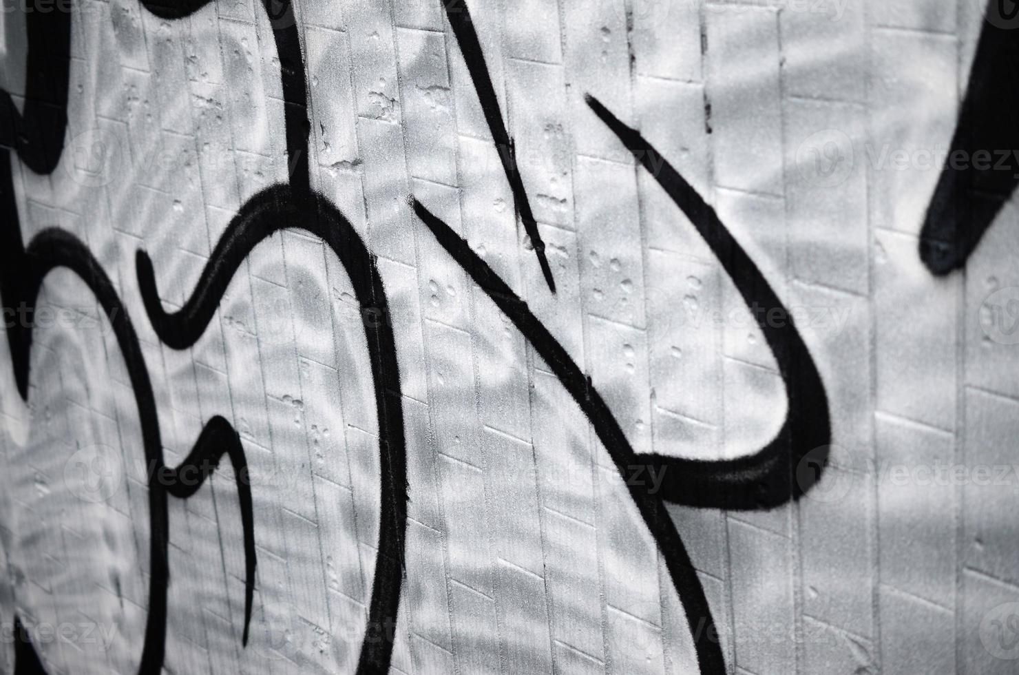 A fragment of a graffiti pattern, applied to a wall of cold tiles, which is covered with a fine condensate. The concept of street art in inappropriate weather photo