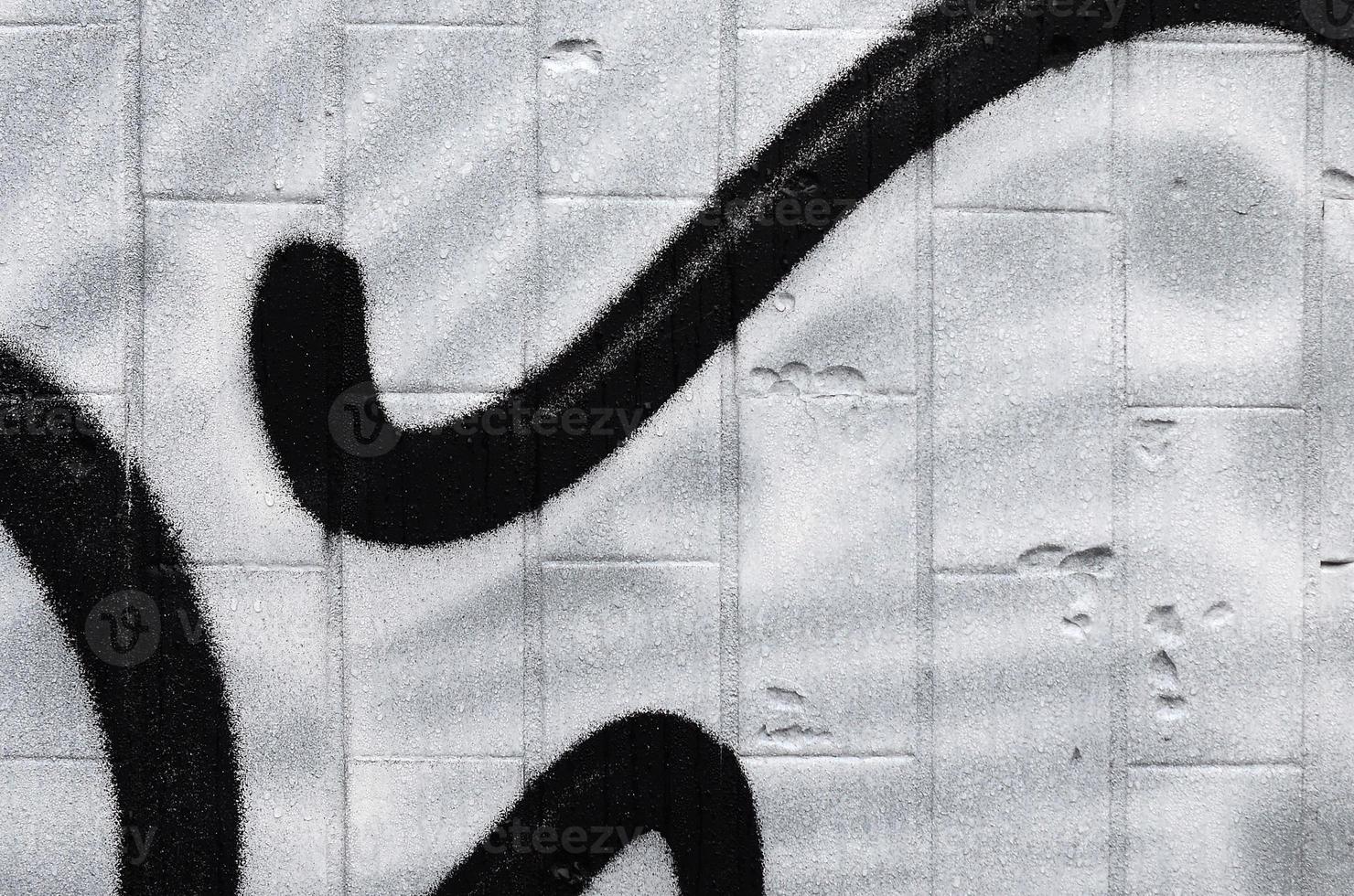 A fragment of a graffiti pattern, applied to a wall of cold tiles, which is covered with a fine condensate. The concept of street art in inappropriate weather photo