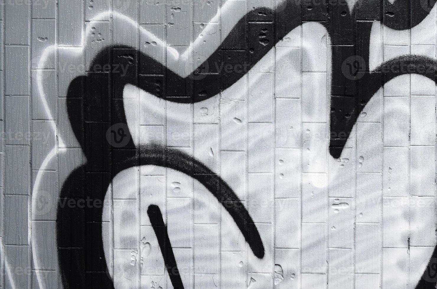 A fragment of a graffiti pattern, applied to a wall of cold tiles, which is covered with a fine condensate. The concept of street art in inappropriate weather photo