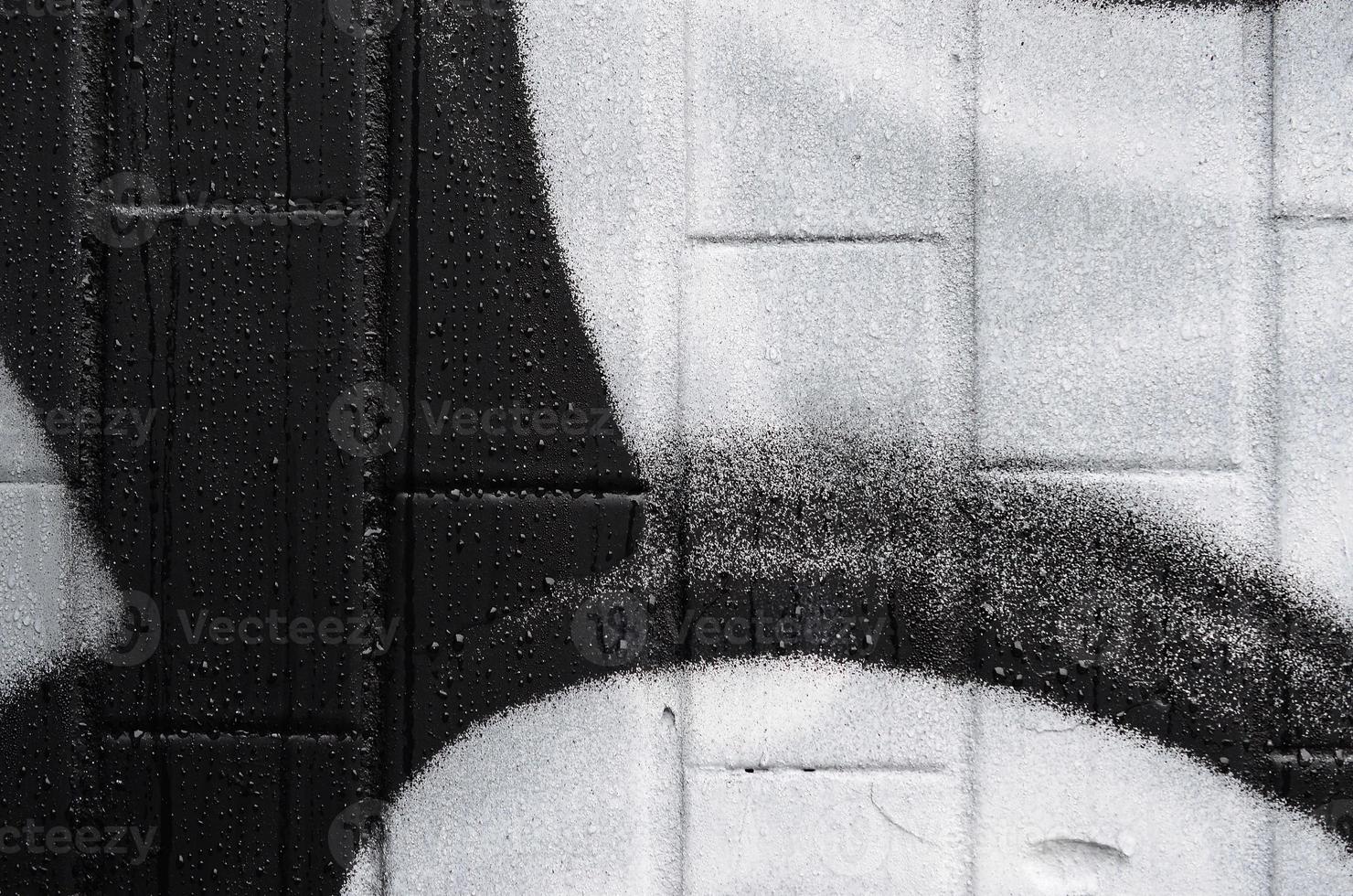 A fragment of a graffiti pattern, applied to a wall of cold tiles, which is covered with a fine condensate. The concept of street art in inappropriate weather photo