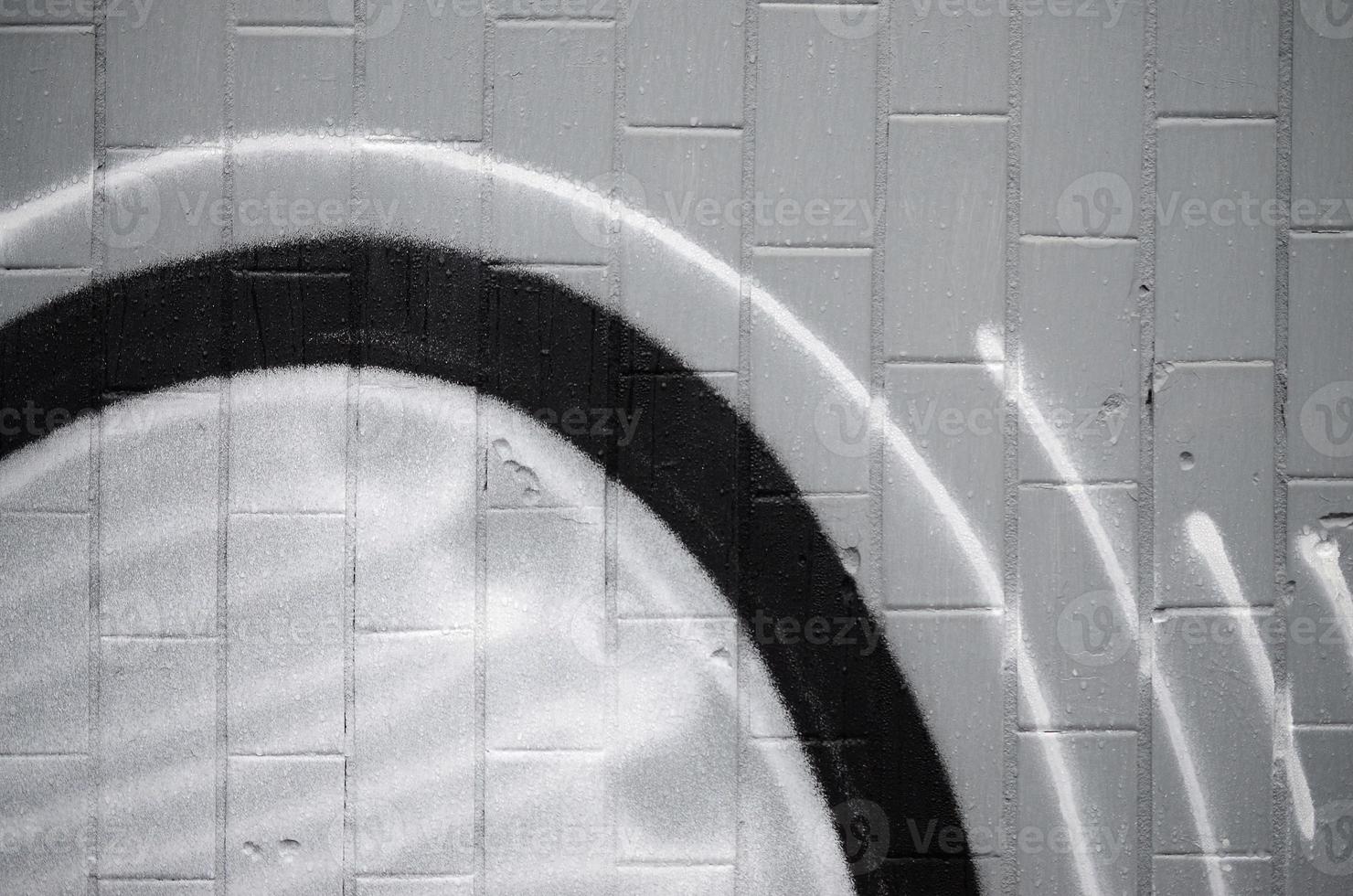 A fragment of a graffiti pattern, applied to a wall of cold tiles, which is covered with a fine condensate. The concept of street art in inappropriate weather photo