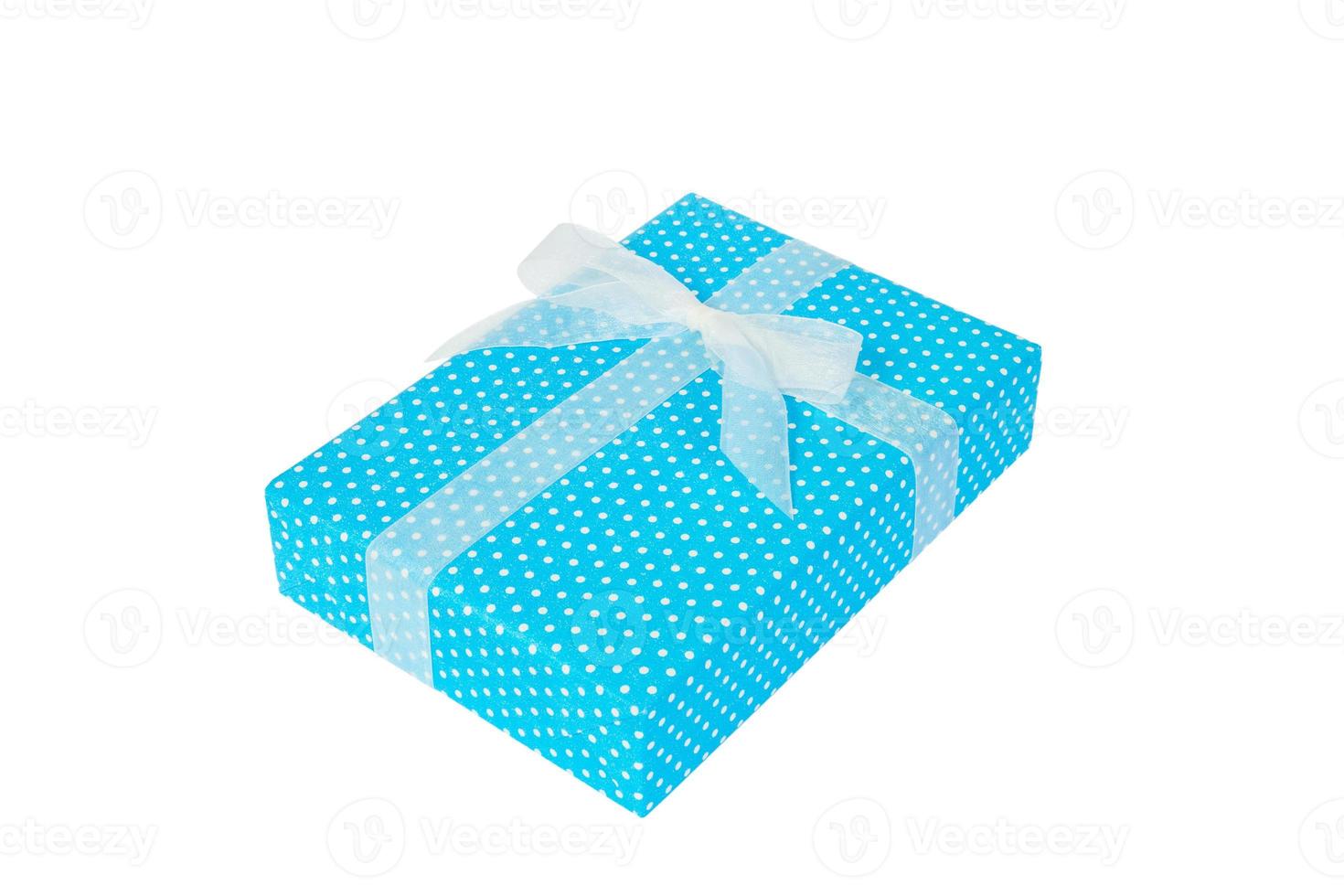Christmas or other holiday handmade present in blue paper with white ribbon. Isolated on white background, top view. thanksgiving Gift box concept photo