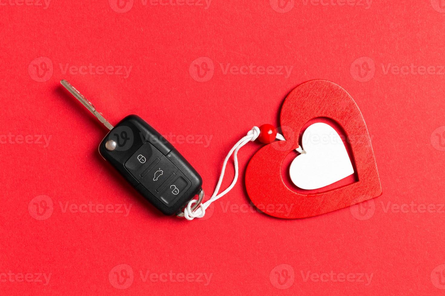 Top view of car key, gift boxes and toy heart on colorful background. Close up of Saint Valentine's Day concept photo