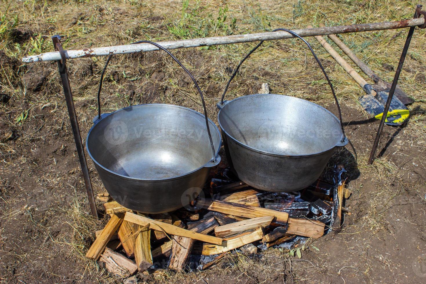 Cooking plov in the cauldron. Only the meat in the cauldron. Field kitchen. Eastern cuisine. photo