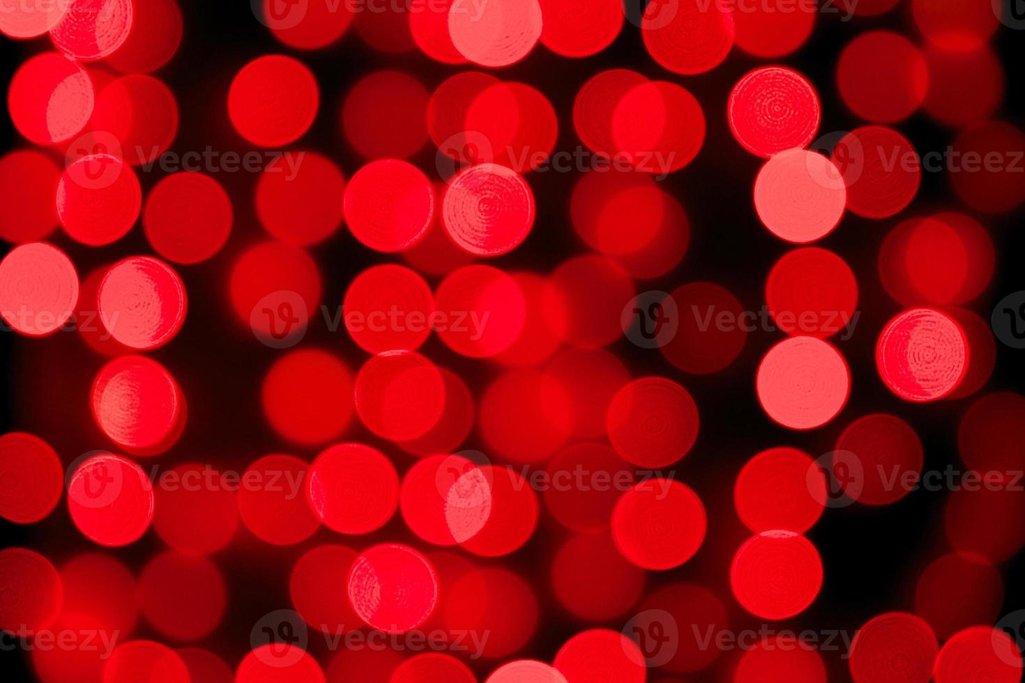 Unfocused abstract red bokeh on black background. defocused and blurred many round light photo