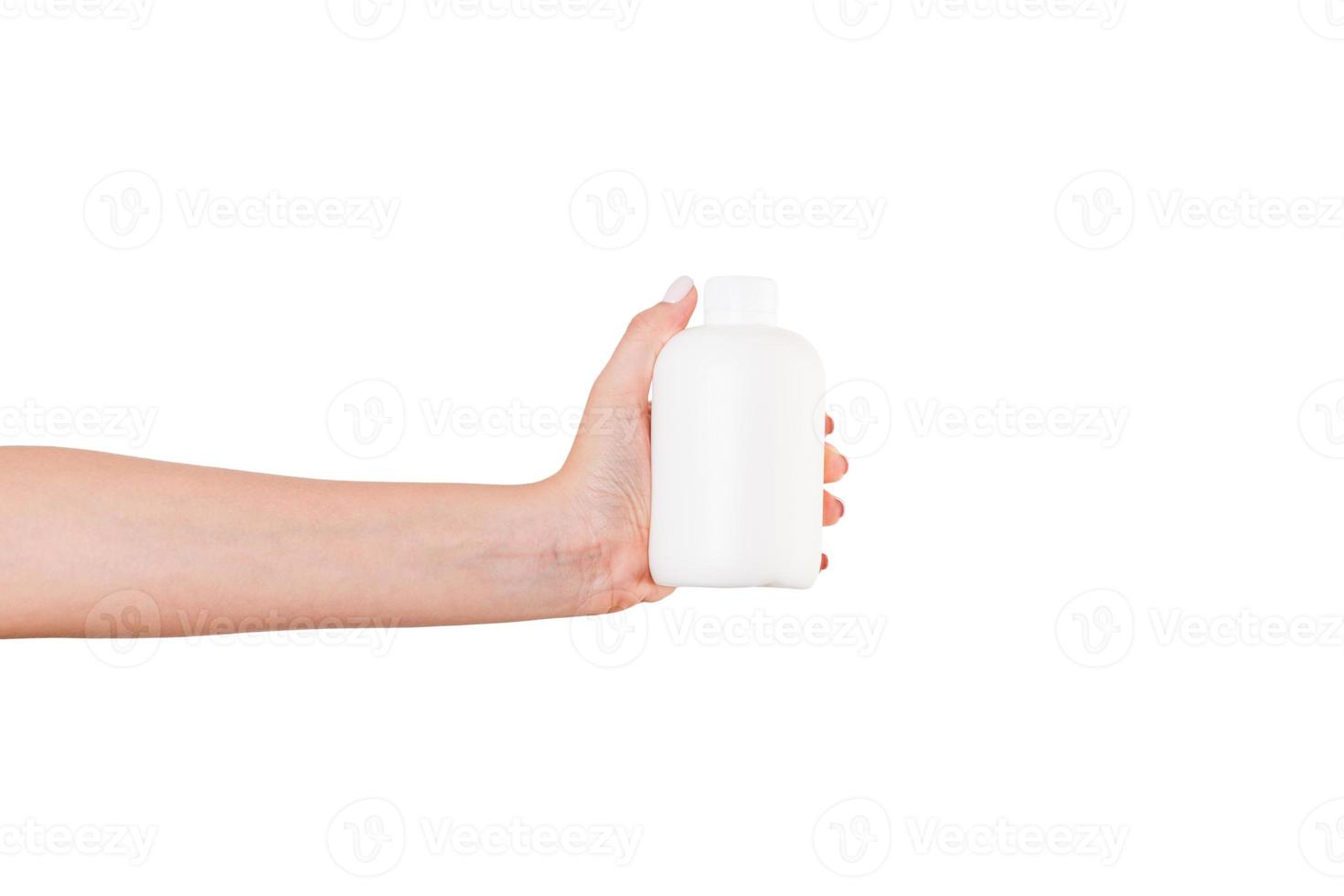 Female hand holding cream bottle of lotion isolated. Girl give tube cosmetic products on white background photo
